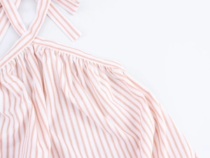Detail of pink and white striped halter neckline with adjustable tie straps on maxi dress