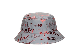 Macro shot of grey bucket hat with red metallic graffiti prints and BABY lettering
