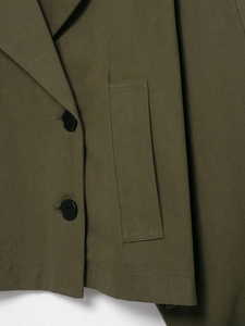 Detail of olive green blazer with double buttons and twill fabric texture