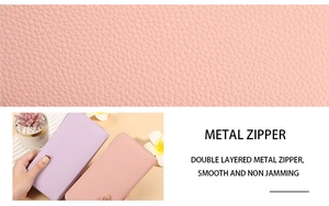 Macro view of smooth double metal zippers on lychee pattern leather wallet for women