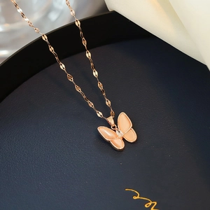 Elegant rose gold butterfly necklace with pink cat-eye stone and crystal on navy base