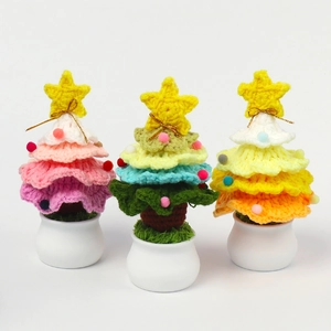 Detailed close-up of handmade crochet Christmas trees with colorful yarn and star toppers