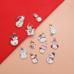 Flat lay of colorful Christmas snowman enamel pendants for DIY jewelry crafting