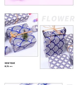 Detail of dark blue gift wrapping paper with white fan patterns and rustic hemp rope