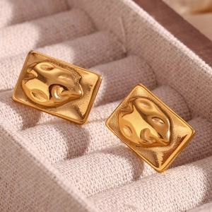 Macro shot of 18K gold-plated irregular rectangular stud earrings with abstract reliefs