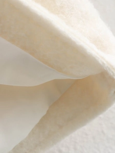 Detailed close-up showing the soft cream sherpa fabric and smooth inner lining texture