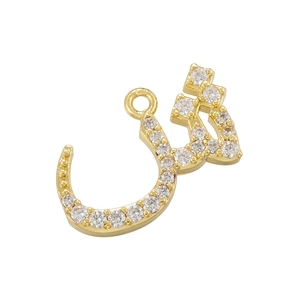 Detailed view of a gold-plated crescent pendant encrusted with clear cubic zirconia stones
