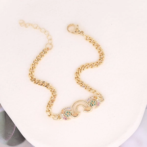 Detail of gold crescent moon bracelet with multi-color zircon inlay and sturdy lobster clasp