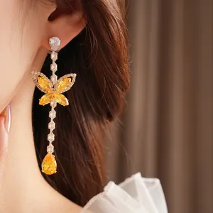 Elegant long drop butterfly earrings with sparkling yellow zircons and gold-plated chains