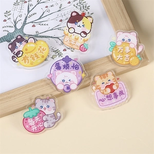 Cute acrylic cartoon cat pins with motivational Chinese blessings on a beige background