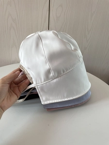 Detail showing various colors of smooth satin hair bonnets with elastic stitching