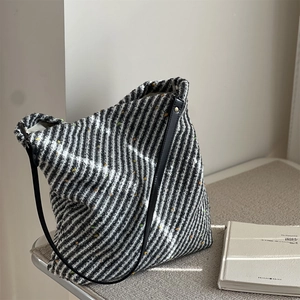 Black and white striped wool tote bag with colorful dot details and leather straps