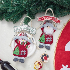 Macro view of Santa and Snowman fabric ornaments with Feliz Navidad wooden signs