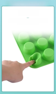 Detail of green silicone muffin mold showing easy release flexible material feature