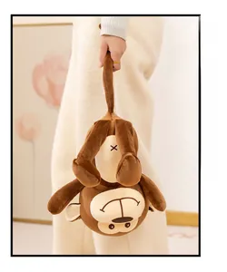 Detail of plush monkey toy with long tail hook and soft brown fabric in home setting