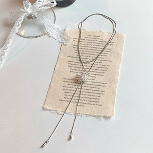 Elegant silver tassel necklace with zircon firework pendant on vintage background