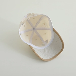 Detail showing internal structure of striped dog baseball cap with six-panel construction