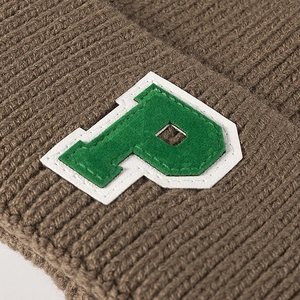 Brown ribbed knit beanie with green and white letter P patch in American college style