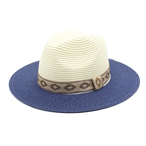Detailed macro view of two-tone straw hat with embroidered diamond pattern ribbon