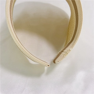 Macro view of woven straw sun hat edge with durable inner striped ribbon reinforcement