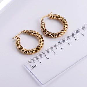 Detail view of gold twisted hoop earrings showing texture and 2.5cm size measurement