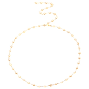 Detail of elegant gold Y-shaped necklace with integrated white round pearls on white base