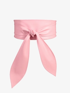 Detail of pink faux leather obi belt with elegant bow tie knot and smooth texture