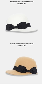 Detail of wool felt equestrian hats in white and beige with black ribbon bow decoration
