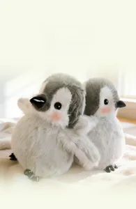 Nahaufnahme von zwei weichen Plüsch-Pinguinen mit flauschiger Textur auf einer Decke