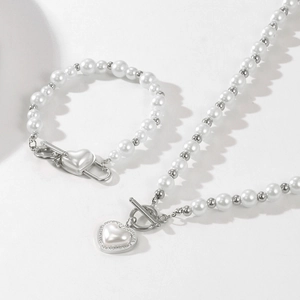 Detail of pearl necklace and bracelet set with silver heart pendants and OT clasp