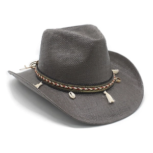 Close-up of gray woven straw cowboy hat with ethnic tassel and shell ornaments