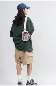 Detailed close-up of a pink transparent PVC crossbody bag with an adjustable strap