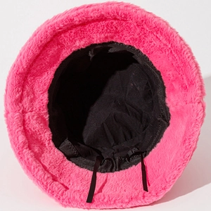 Detail of pink plush bucket hat showing the inner fabric lining and adjustable black drawstring