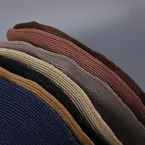 Close-up of handmade woven straw hats showing detailed texture in various colors