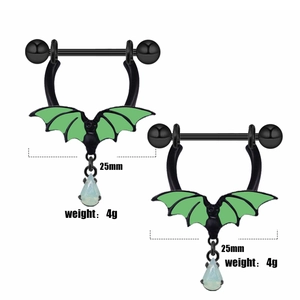 Detail of bat-themed nipple rings with green wings and light blue teardrop opal charms