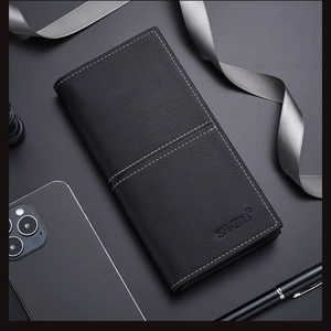 Close-up of black leather slim wallet with white stitching and embossed logo detail