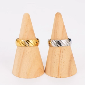 Minimalist stainless steel ring set with diagonal stripes and zircon inlay on wood stand