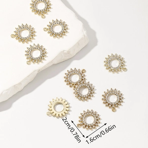 Gold sunburst rhinestone pendant necklace with dimensions 2cm x 1.6cm on stone backdrop