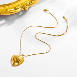 Elegant 18K gold plated stainless steel necklace with textured heart pendant on white background