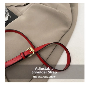 Detail of adjustable red synthetic leather shoulder strap with golden metal buckle