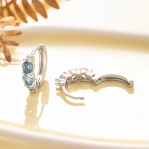 Elegant copper earrings with three round cubic zirconia stones in pink and blue
