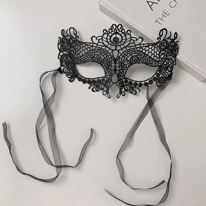 Elegant black lace masquerade mask with intricate cut-out patterns and satin ribbons