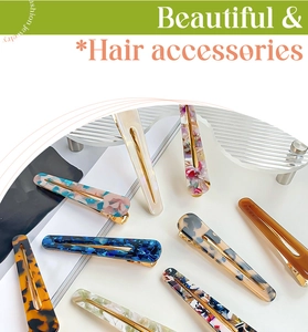 Close-up of tortoise shell and marble acetate hair clips on display stand