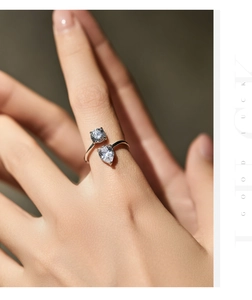 Close-up of S925 sterling silver ring with asymmetric round and pear-shaped crystals