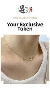 Detail of 18K gold-plated cross necklace with zircon stone on female model neckline