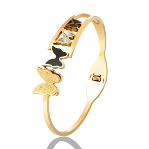 Elegant gold butterfly opening bangle bracelet with black and silver enamel charms