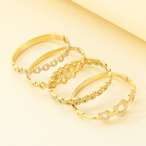Detail view of five-piece gold stainless steel bracelet set with white rhinestones