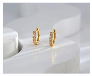 Close-up of gold-plated hoop earrings featuring double rows of micro-pave white zircons