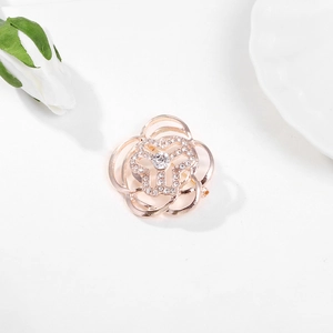 Elegant rose gold flower brooch with sparkling crystals on a minimalist white background