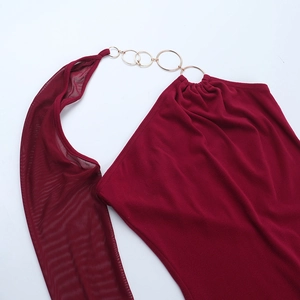 Detail of burgundy dress with sheer mesh sleeve and decorative gold rings